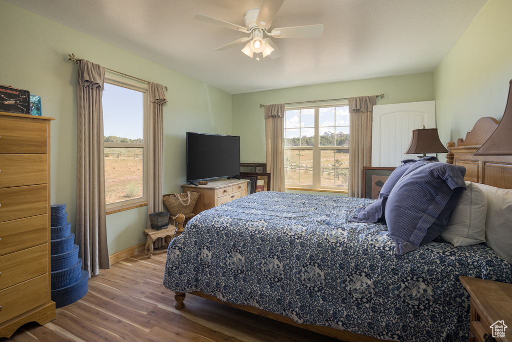 Bedroom featuring wood-type flooring and ceiling fan