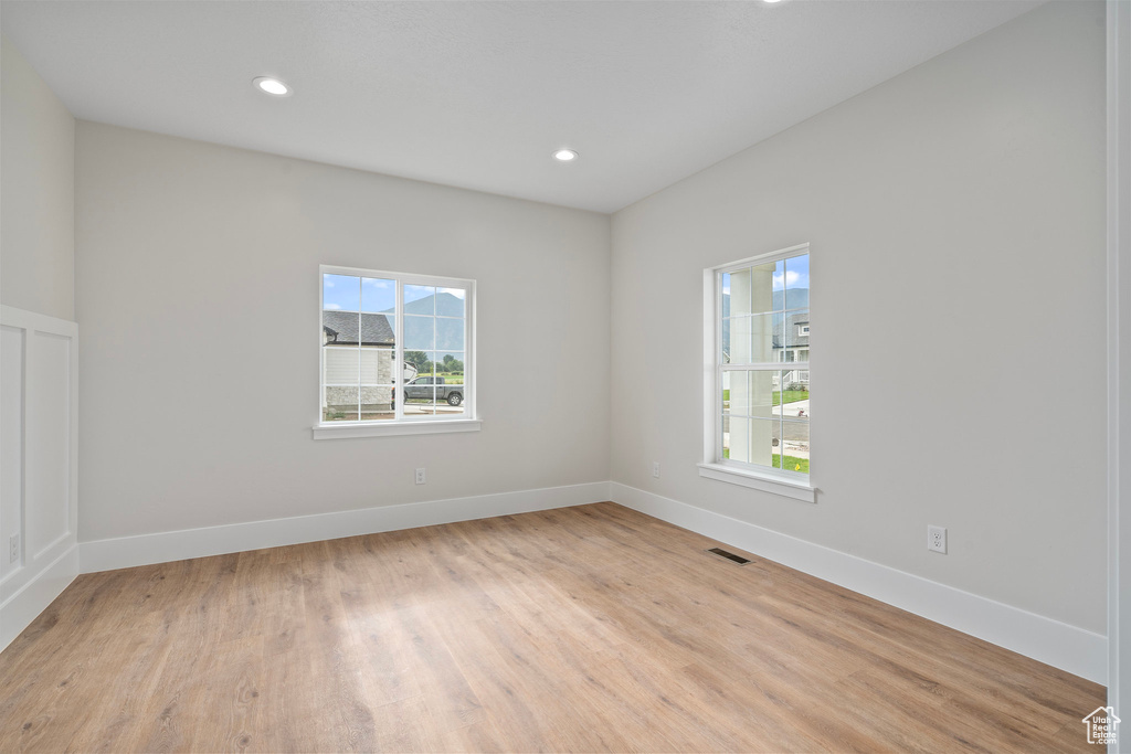 Unfurnished room with light hardwood / wood-style floors