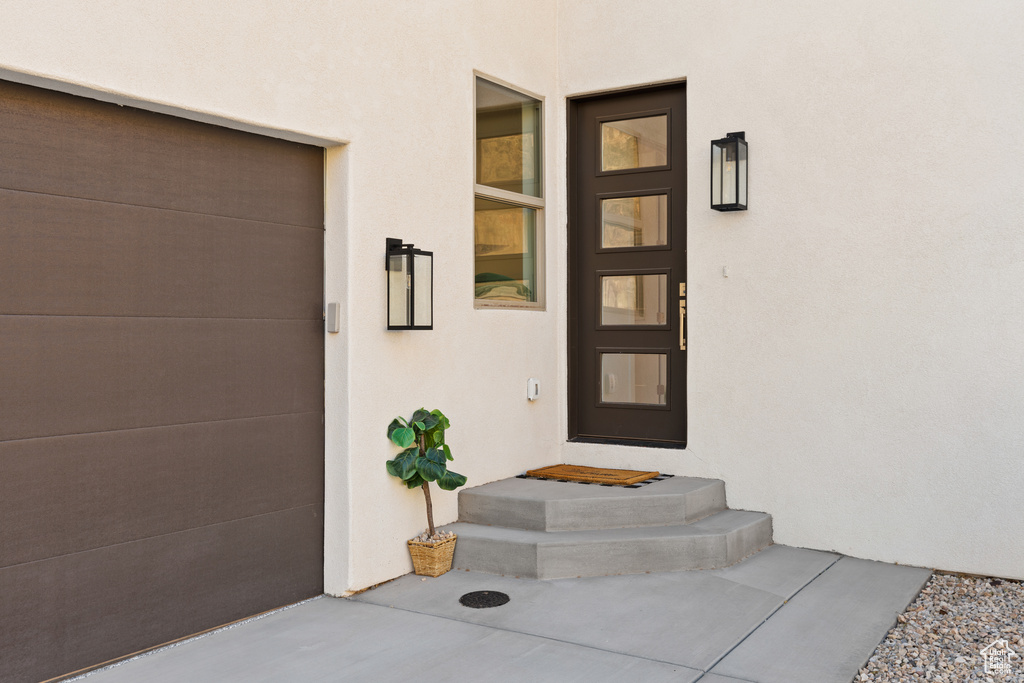 Entrance to property with stucco siding