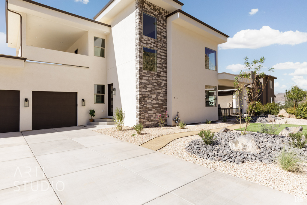 View of property exterior with a garage and elevator