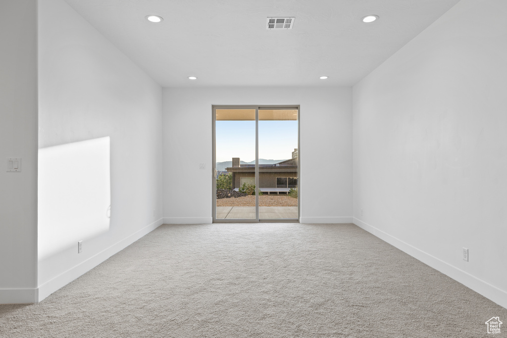 Spare room featuring recessed lighting and carpet flooring