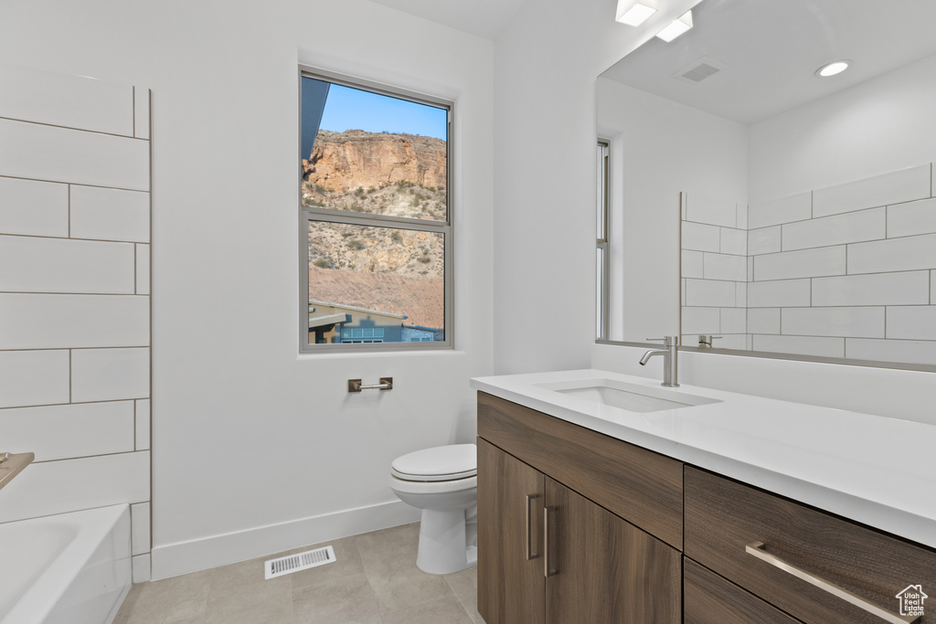 Bathroom featuring vanity, tile patterned floors, and bathing tub / shower combination