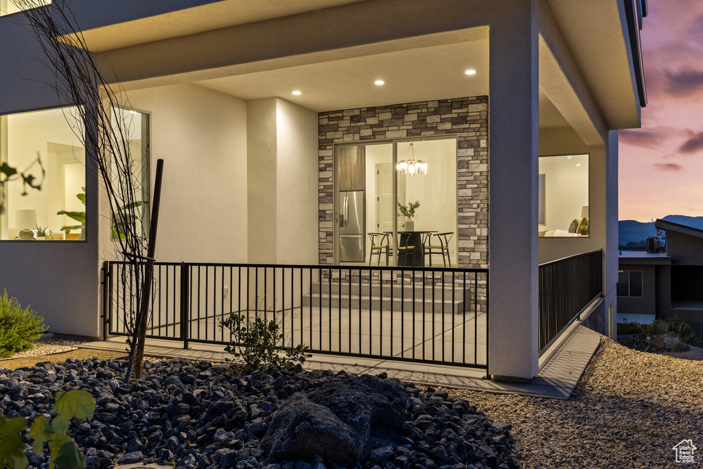 View of exterior entry featuring stucco siding and stone siding