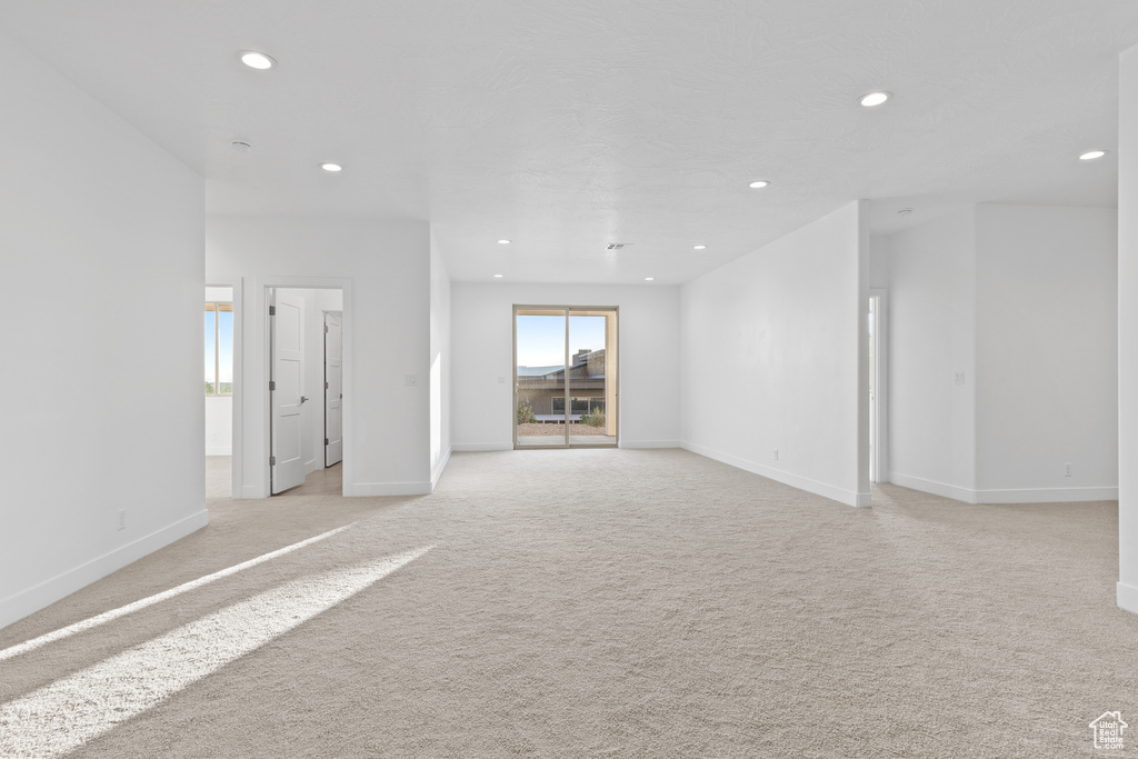 Empty room featuring recessed lighting and light colored carpet