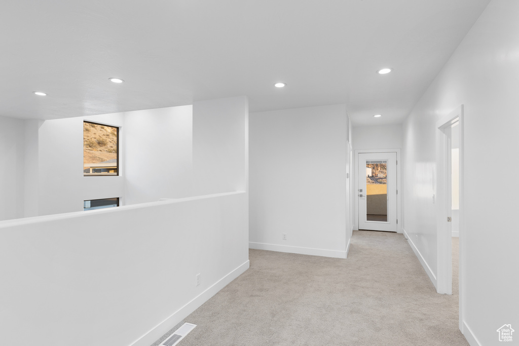 Hall with recessed lighting and carpet floors