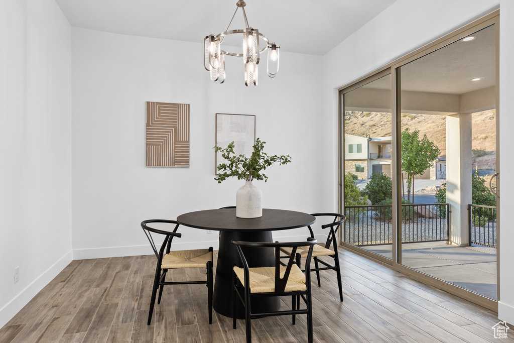 Dining room with a chandelier and wood finished floors