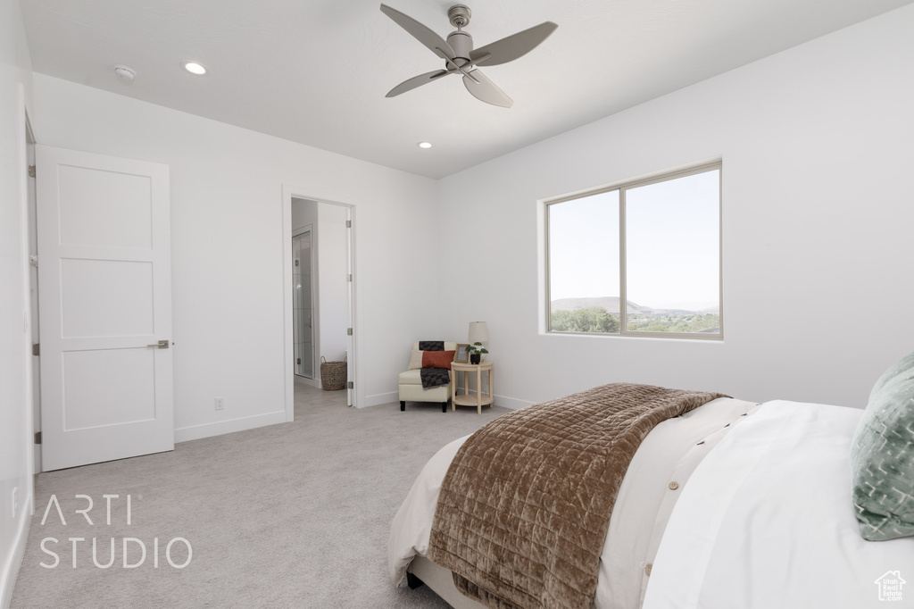 Carpeted bedroom featuring ceiling fan