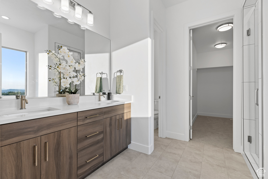 Bathroom featuring double vanity and tile patterned floors