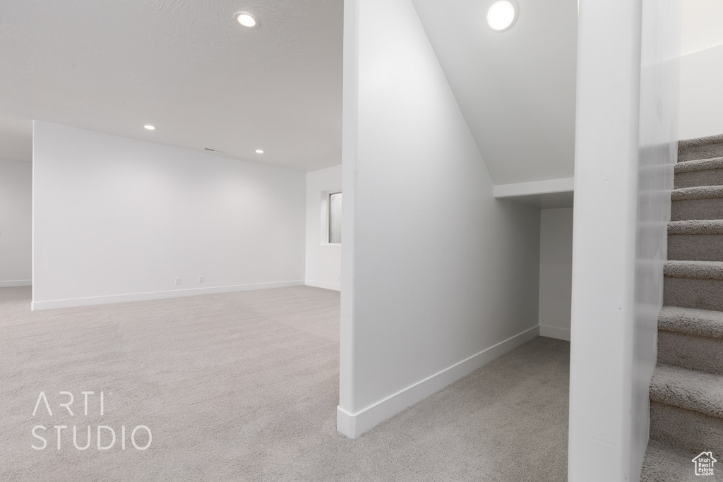 Stairs featuring lofted ceiling and carpet flooring