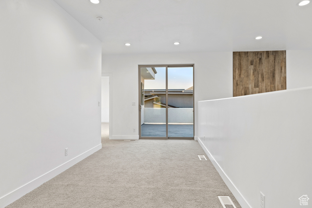 Carpeted spare room featuring recessed lighting