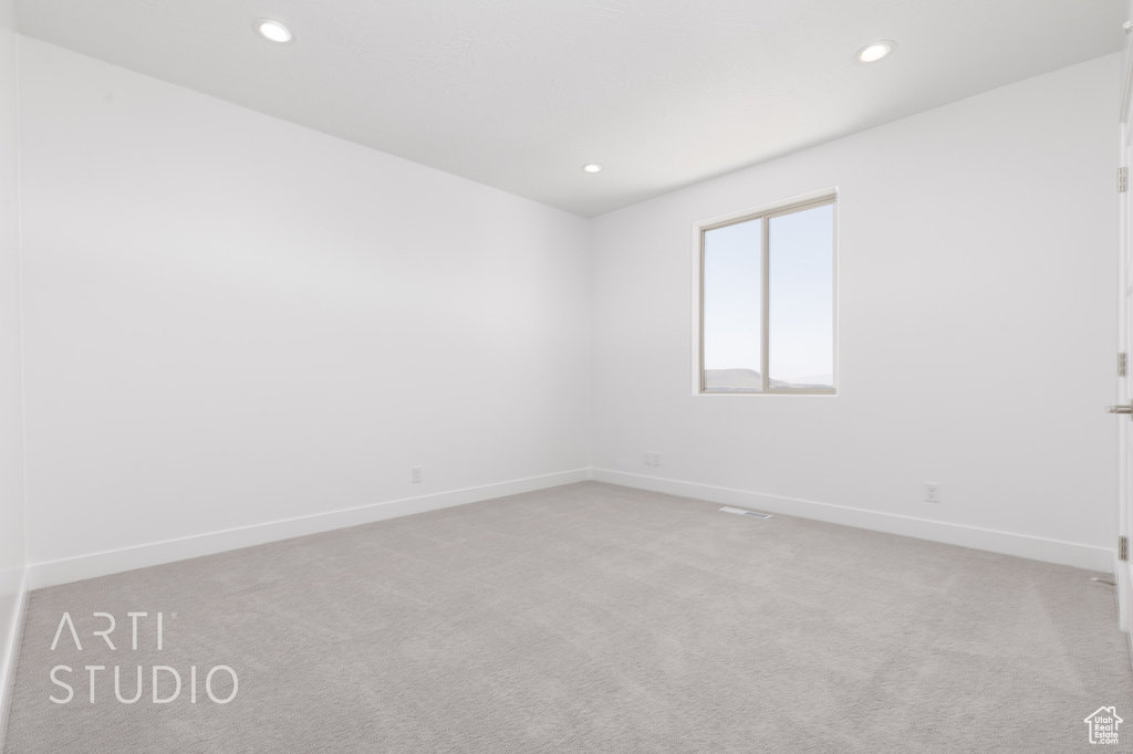 Empty room with light colored carpet