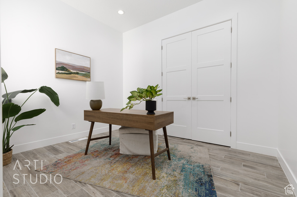 Home office featuring light hardwood / wood-style floors