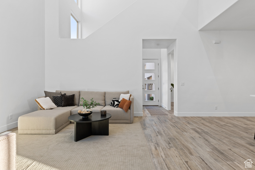 Living room with a towering ceiling and wood finished floors