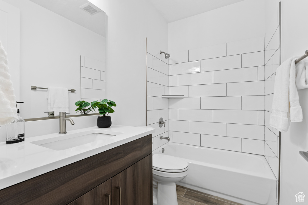 Full bath with vanity, shower / washtub combination, and wood finished floors