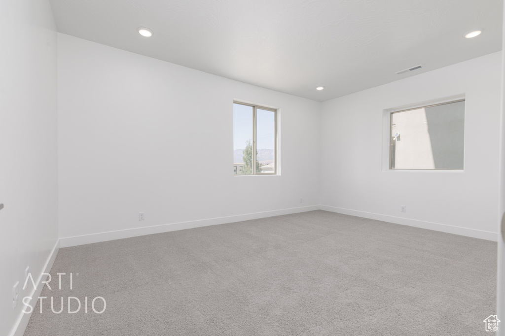 Unfurnished room featuring light colored carpet