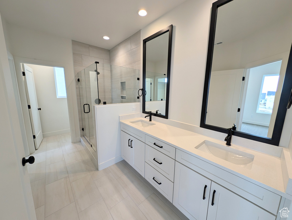 Bathroom with walk in shower, dual bowl vanity, and tile patterned floors