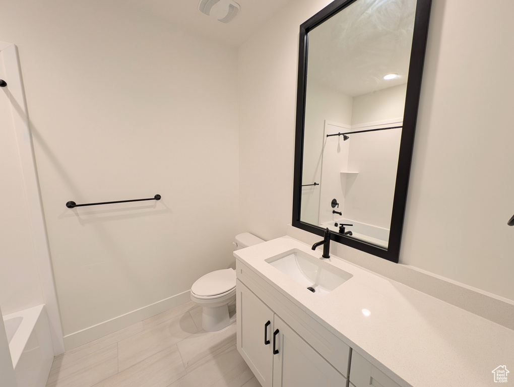 Full bathroom featuring tile patterned floors, vanity, toilet, and shower / bathing tub combination