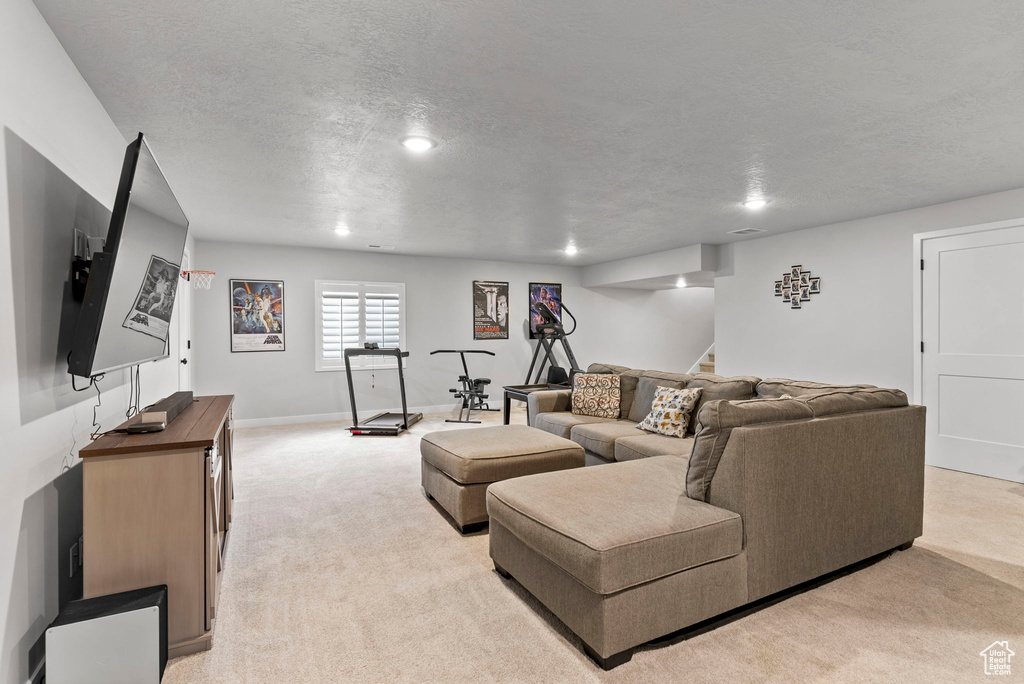 Carpeted living room featuring a textured ceiling