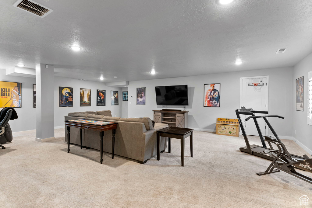 Living room with a textured ceiling and light carpet