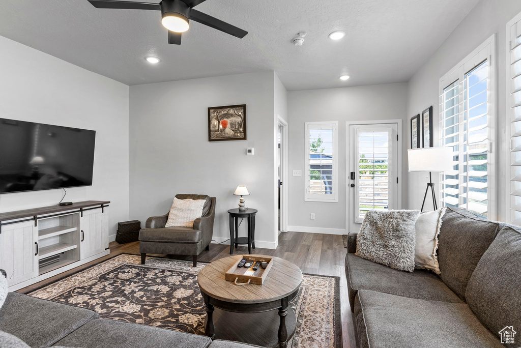 Living room featuring light wood-type flooring and ceiling fan