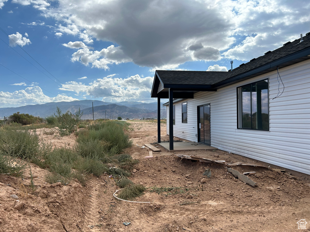 View of yard with a mountain view and a patio area