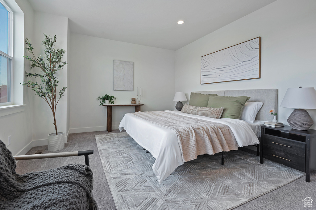 Bedroom with light colored carpet