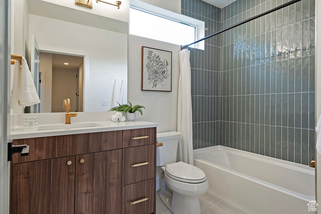 Full bathroom with vanity, toilet, and shower / bath combo