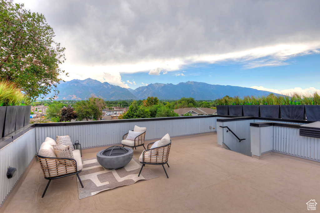 View of patio featuring a mountain view and a fire pit