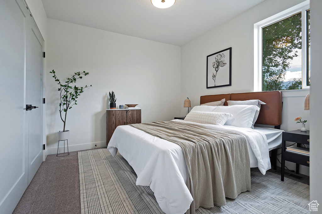 Bedroom featuring light colored carpet