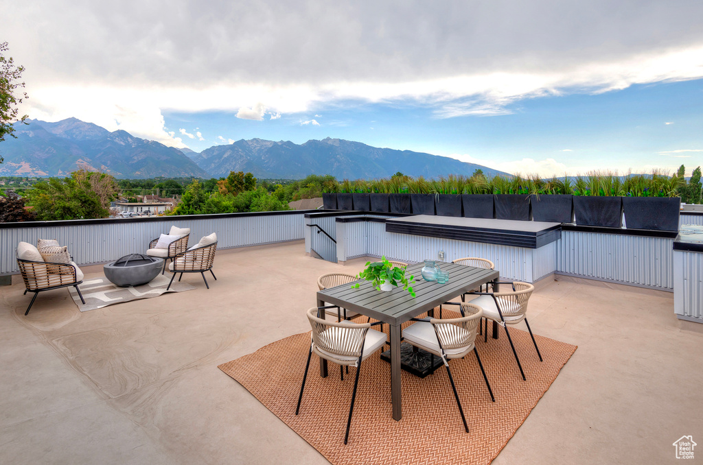 View of patio featuring a mountain view and a fire pit