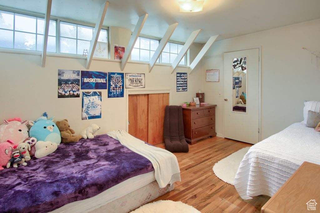 Bedroom with light wood-type flooring and multiple windows