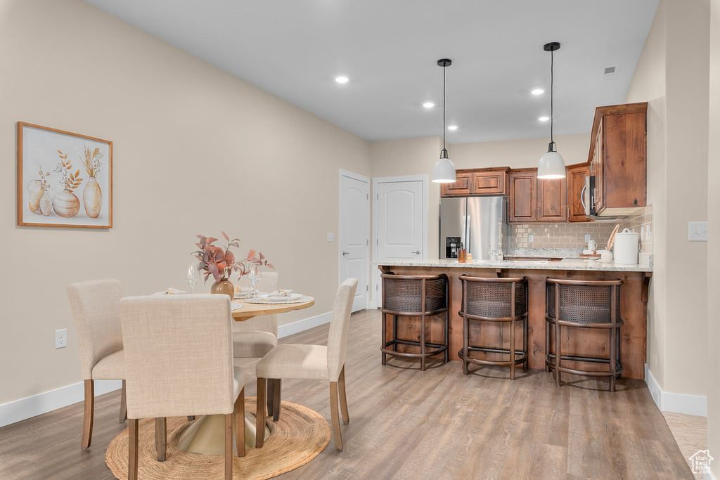 Dining space with light wood-type flooring