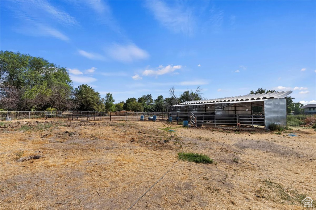 View of yard featuring a rural view and an outdoor structure