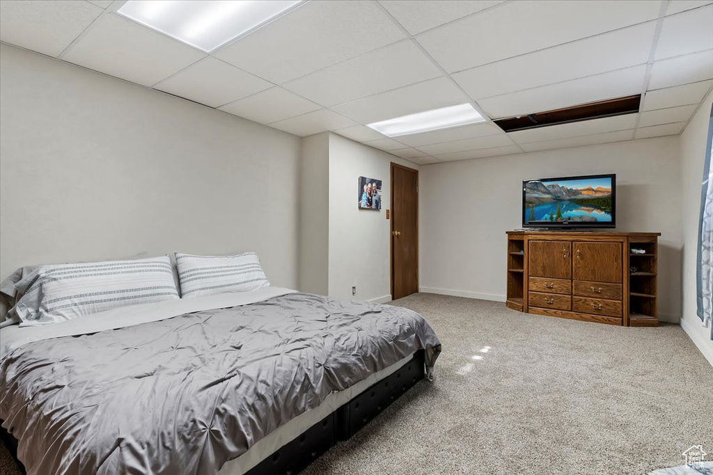 Carpeted bedroom featuring a paneled ceiling