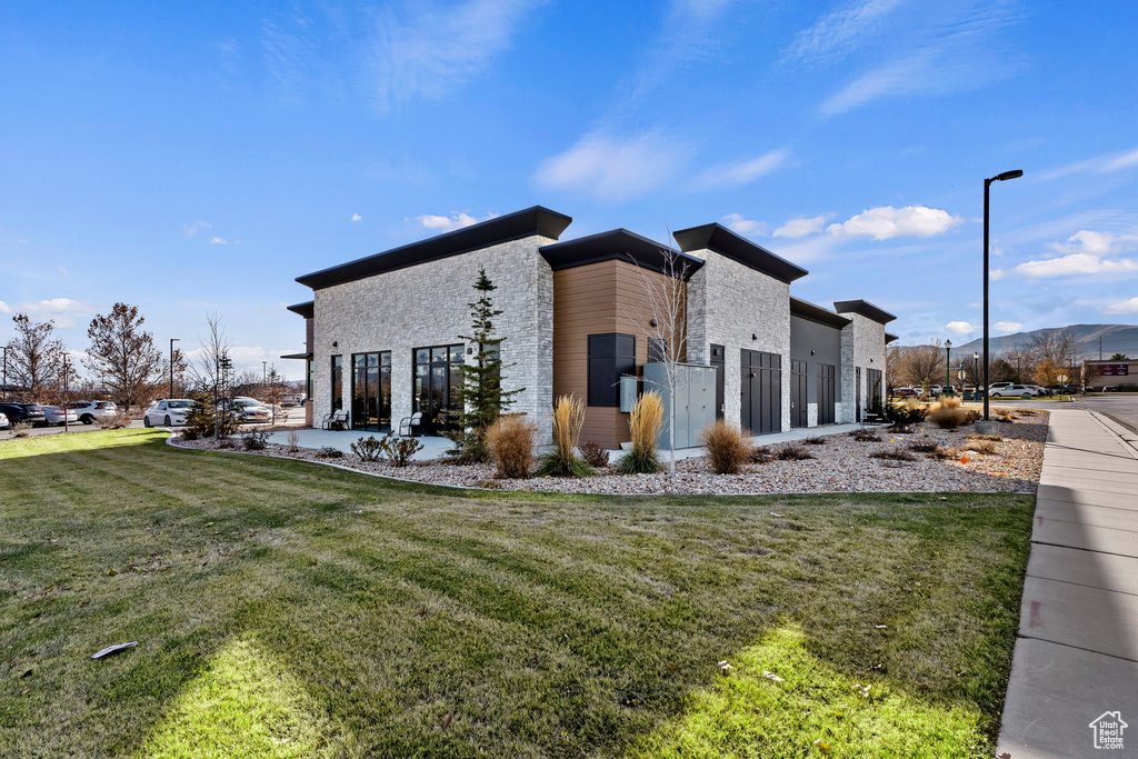 View of property exterior featuring a yard