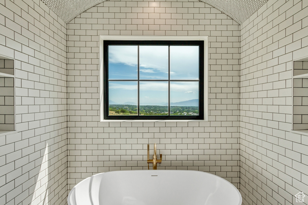 Bathroom featuring tile walls