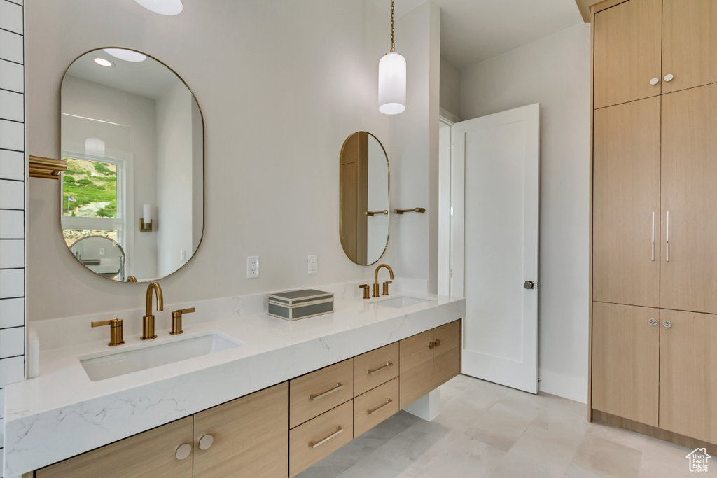 Bathroom with double vanity and tile patterned flooring