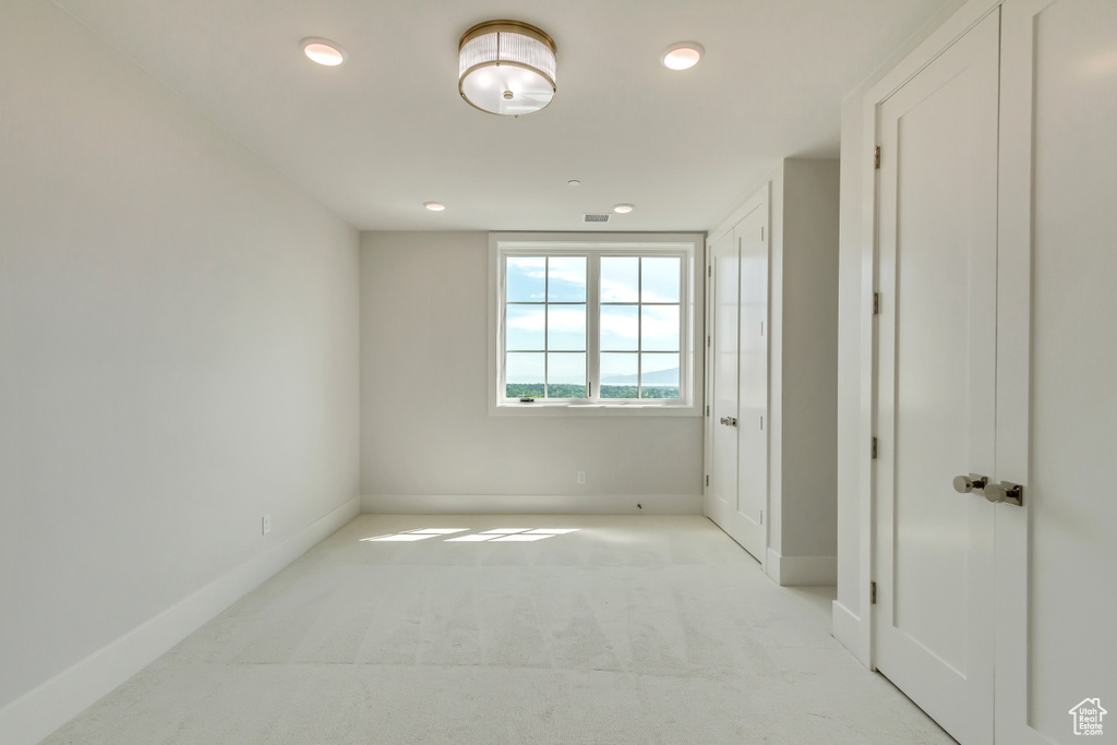 Unfurnished bedroom featuring light colored carpet