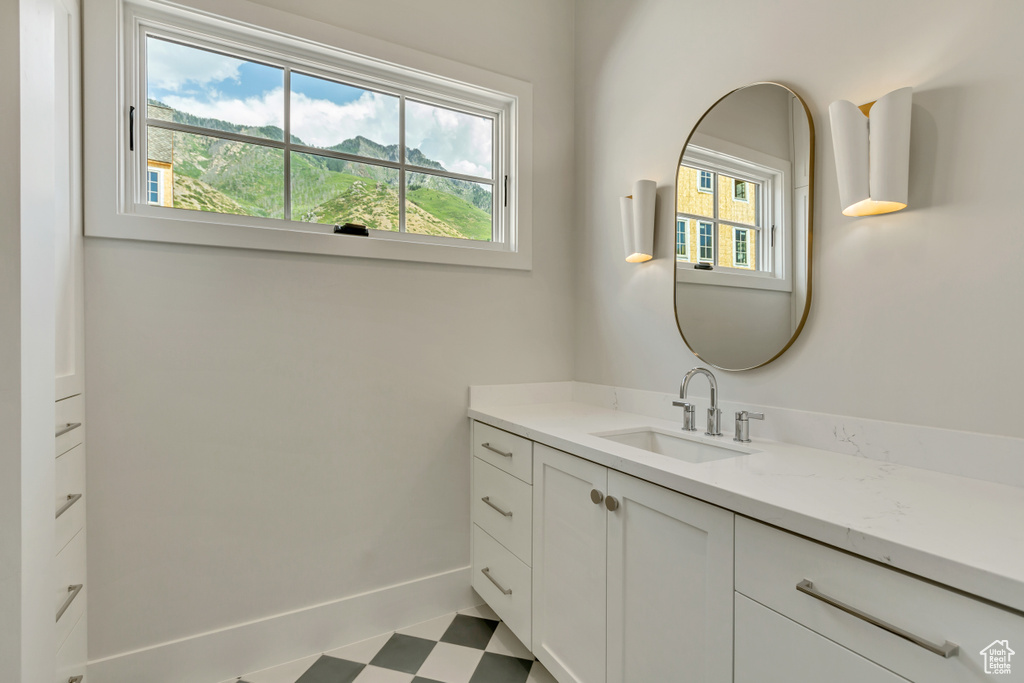 Bathroom featuring vanity, plenty of natural light, and tile patterned flooring