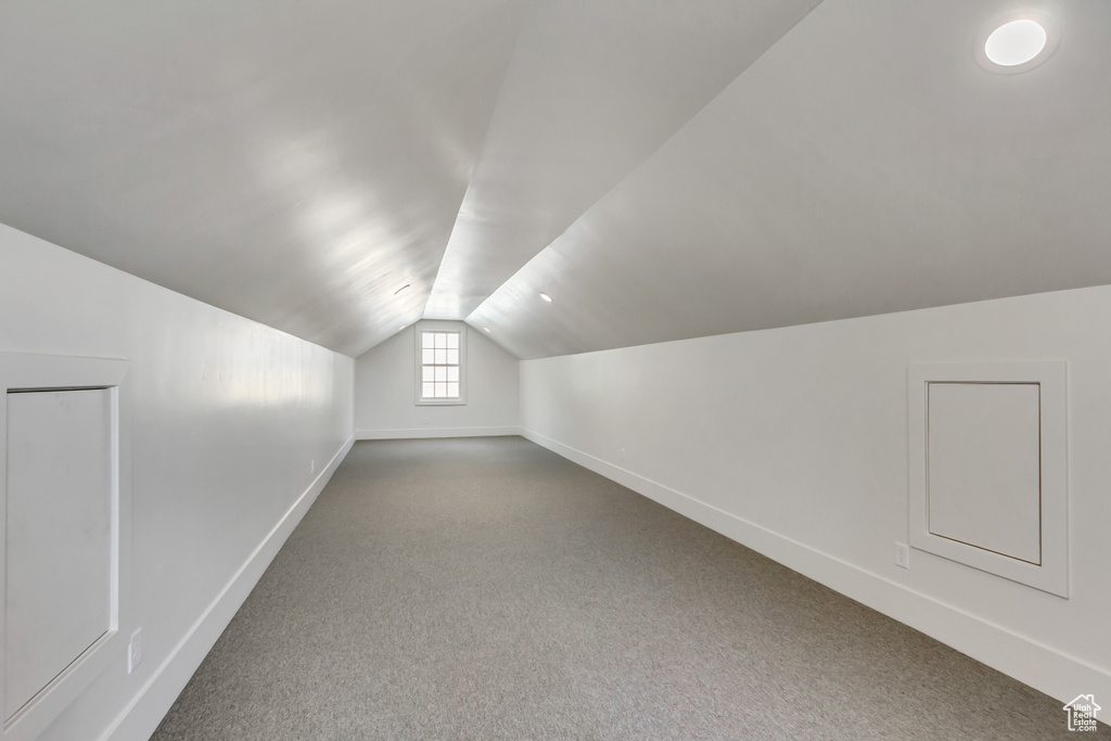 Bonus room with carpet floors and vaulted ceiling