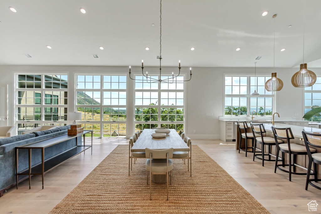 Dining area with a chandelier and light hardwood / wood-style floors