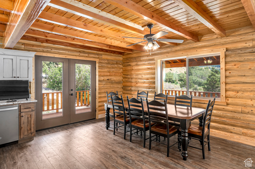 Dining space with beam ceiling, french doors, dark wood-type flooring, and wood ceiling
