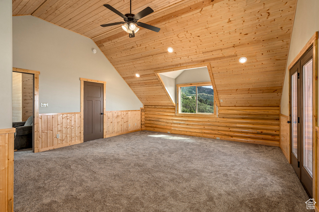 Bonus room with rustic walls, wood ceiling, and ceiling fan