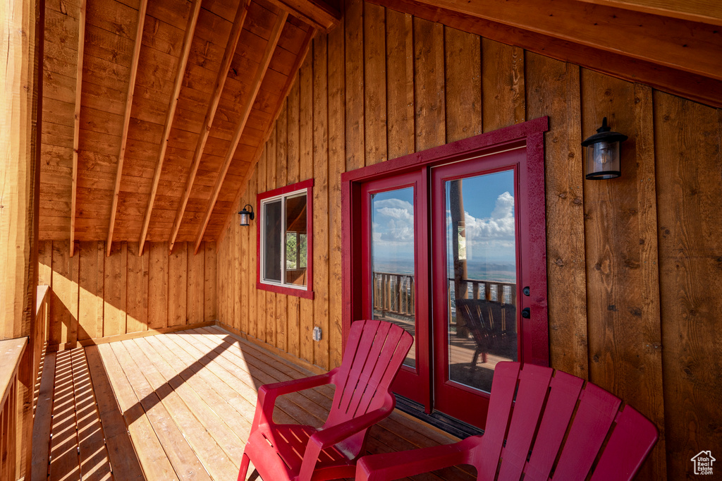 Exterior space with hardwood / wood-style floors, wood ceiling, wooden walls, and a wealth of natural light