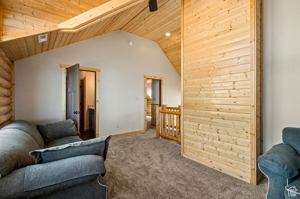 Sitting room featuring wood ceiling, vaulted ceiling, and carpet floors