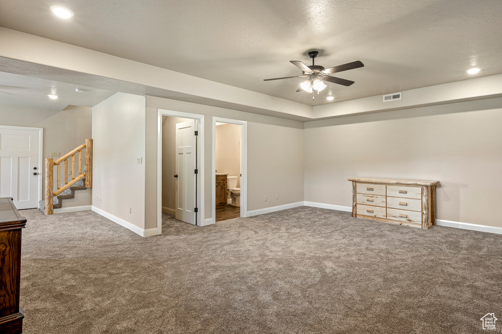 Basement with ceiling fan and carpet flooring
