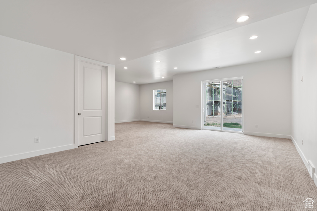 Empty room featuring light colored carpet