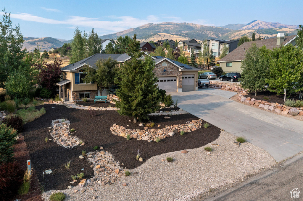 View of front of house featuring a mountain view and a garage