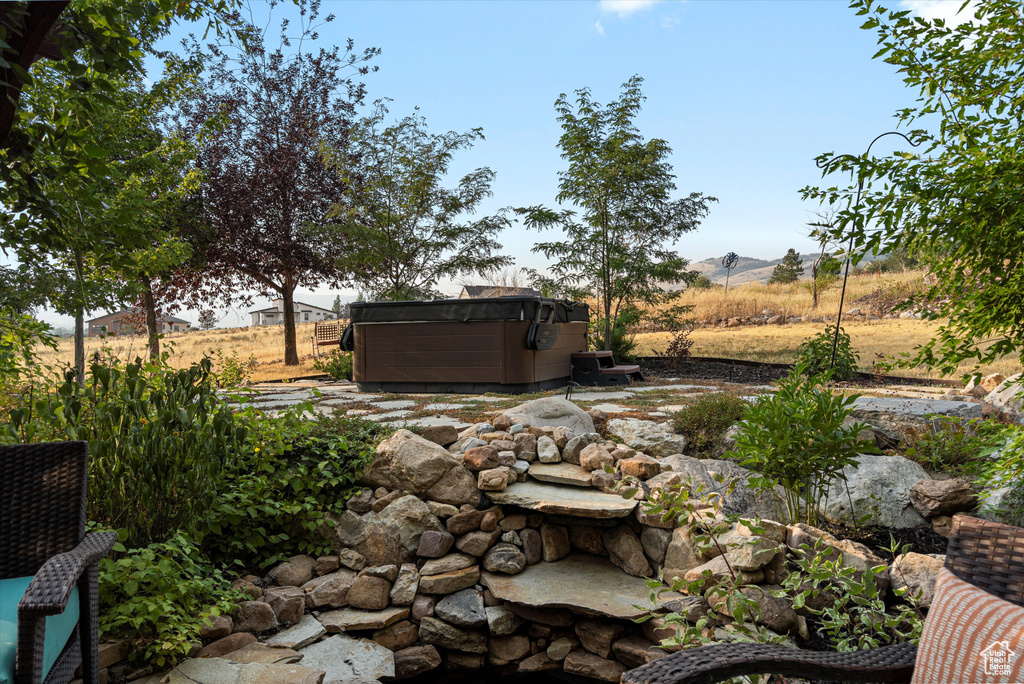 View of yard featuring a hot tub and a rural view