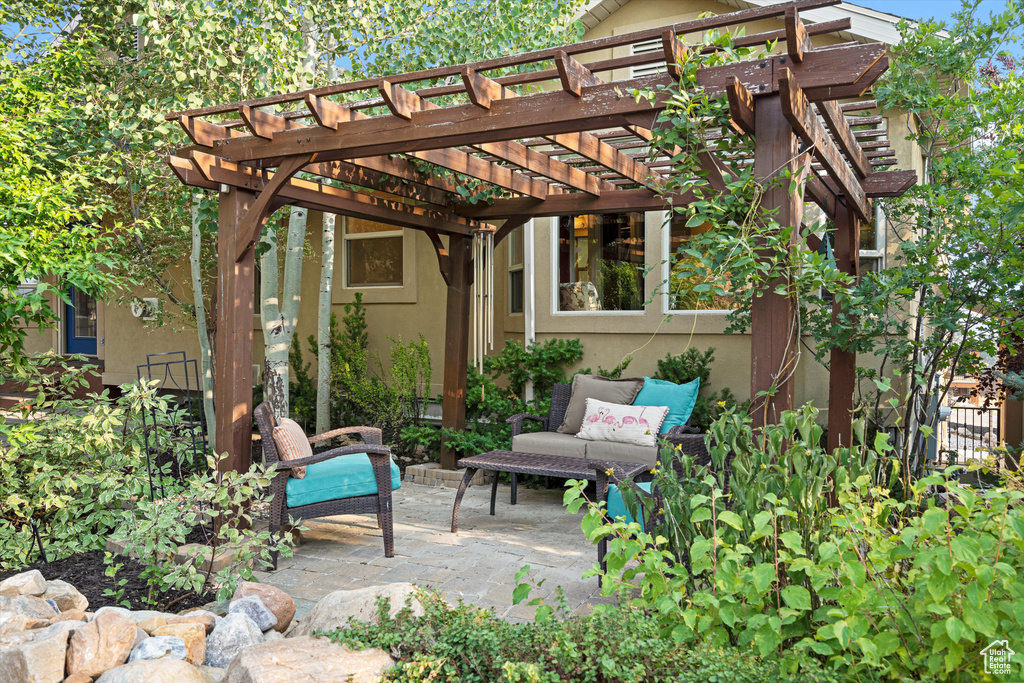 View of patio featuring a pergola and an outdoor hangout area